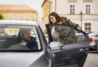 A female customer riding a car of ride hailing service Uber