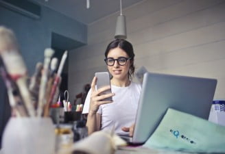 a girl with glasses holding a smartphone, reduce digital eye strain