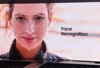 A picture of presentation screen showing a face with face recognition feature at Samsung event