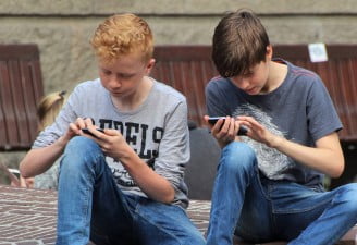 two kids using their phones