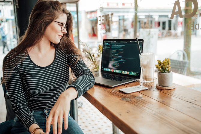 A Girl Who Codes Sitting On A Table With Her Table