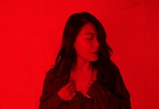 A red tone photo of a girl with anxiety