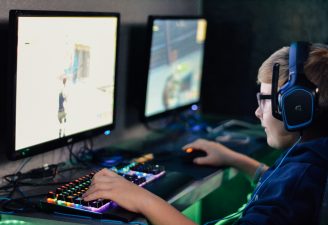 A kid playing video games on his computer