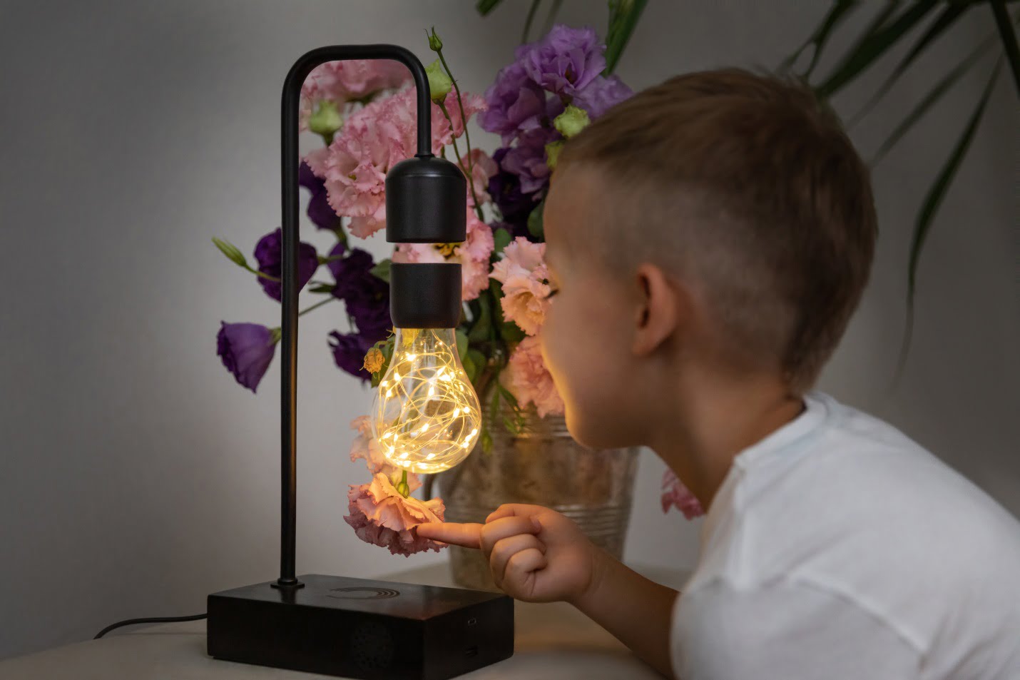 A Kid Playing With The Bulb Gravita